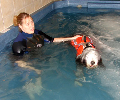 Baillie in a pool having hydrotherapy with his therapist